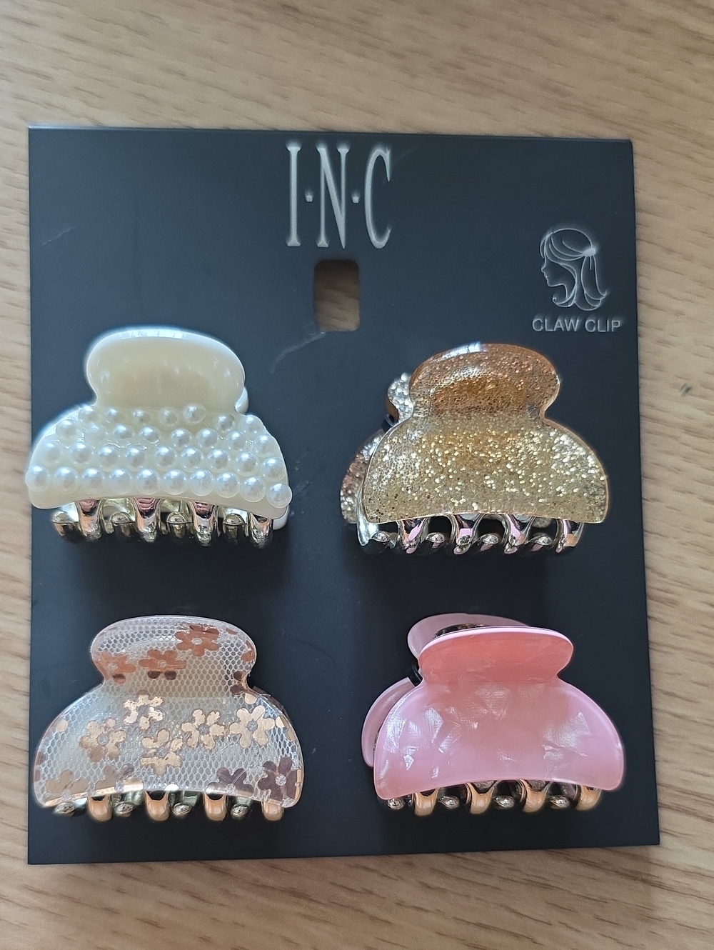 I.N.C. hair accessory set includes four distinct small acrylic claw clips.
